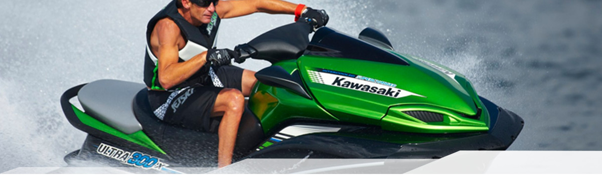 Man on a green Kawasaki JET SKI® Ultra 300X cruising the water.